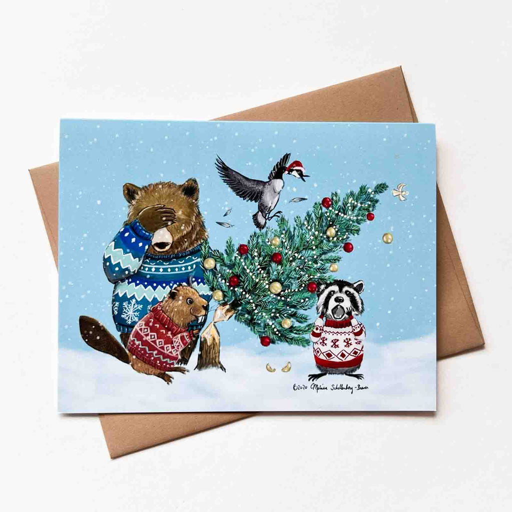 A funny Christmas greeting card featuring a beaver gnawing down a Christmas tree, to the horror of his animal friends: a bear, a Canadian goose, and a raccoon.