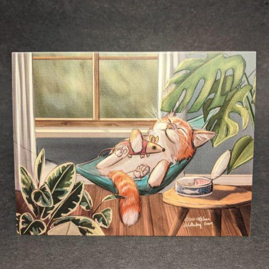 a cat lounging in a hammock with a can of tuna beside him