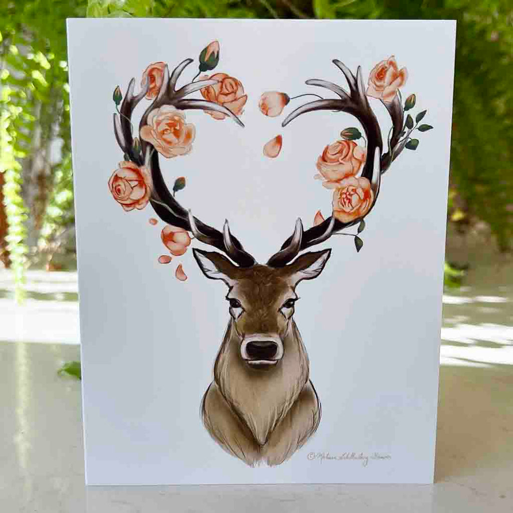 a love card featuring a majestic stag with heart shaped antlers surrounded by coral coloured roses. 